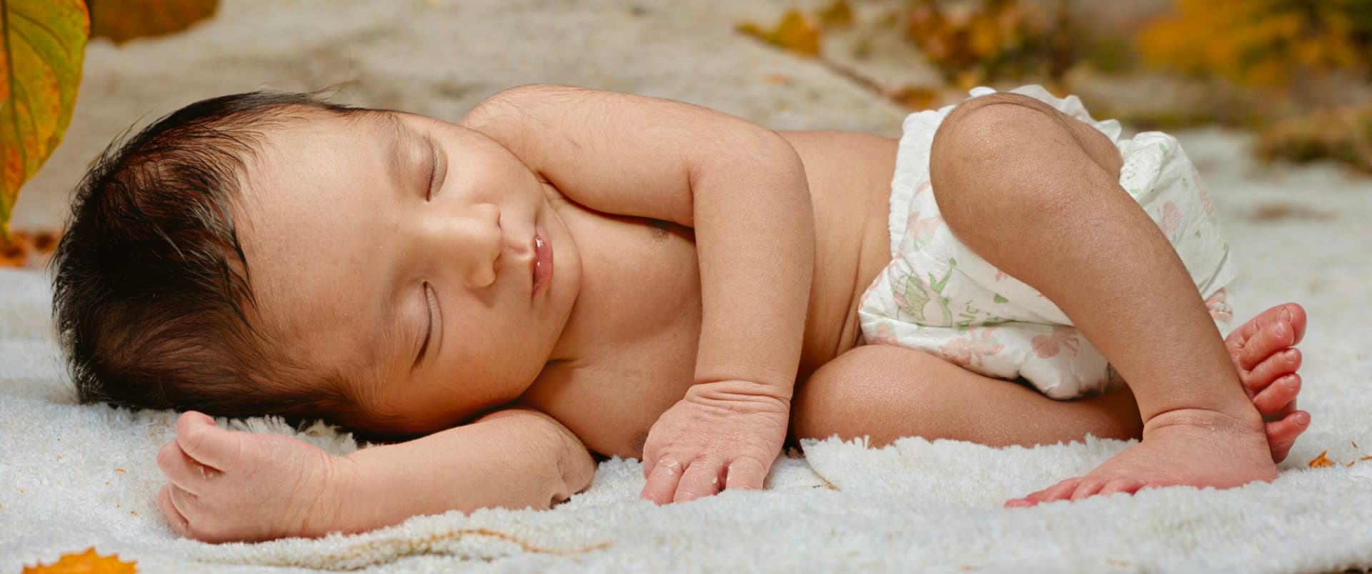 Sleeping newborn photographed in soft natural light